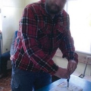 David Lupton cutting the 50th anniversary cake in the WHS Lupton Hut, 31/10/15.
