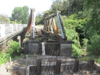 Old wooden bridge trusses which will remain in place.
