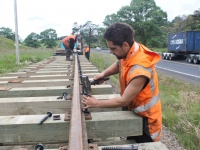 Goldfields railway ganger taps bolt into place.